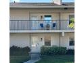 Exterior view of condos with a balcony and well-maintained landscaping at 2607 Woodgate Ln # K9, Sarasota, FL 34231