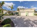 Beautiful single-story home boasting a paver driveway, a two-car garage, and decorative glass front door at 333 Bayshore Dr, Venice, FL 34285