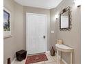 Inviting condominium foyer with neutral tones, decorative mirror and tasteful accents at 3803 54Th W Dr # 203, Bradenton, FL 34210