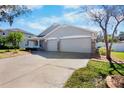 A charming single story house with a three-car garage and lush landscaping at 4110 Noble Pl, Parrish, FL 34219