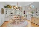 Charming dining room with a classic chandelier, built-in display cabinets, and a round rug under the table at 4306 Presidential Avenue E Cir, Bradenton, FL 34203
