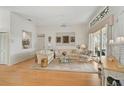 Bright living room featuring hardwood floors, a decorative window, and a sliding glass door leading outside at 4306 Presidential Avenue E Cir, Bradenton, FL 34203