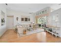 Bright living room featuring hardwood floors, a decorative window, and a sliding glass door leading outside at 4306 Presidential Avenue E Cir, Bradenton, FL 34203