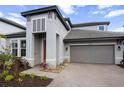 Close-up of a modern home with a two-car garage and well-kept landscaping at 4793 Antrim Dr, Sarasota, FL 34240