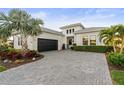 Charming home featuring a paved driveway, beautiful landscaping, and an attached garage at 5074 Surfside Cir, Bradenton, FL 34211