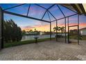 Screened patio overlooking a serene lake with fountain, offering stunning views and outdoor living at 5074 Surfside Cir, Bradenton, FL 34211