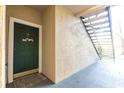 Close-up of an entryway showcasing a door with a welcome sign and nearby stairs at 5122 Northridge Rd # 110, Sarasota, FL 34238