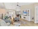 Bright, open-concept living room boasts wood flooring and a built-in entertainment center for modern comfort at 5320 Crestlake Blvd # 26, Sarasota, FL 34233