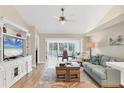 Cozy living room featuring wood floors, stylish furnishings, and sliding glass doors to a screened lanai at 5320 Crestlake Blvd # 26, Sarasota, FL 34233