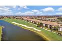 Aerial view of a beautiful residential complex with a manicured golf course and water view at 5710 Palmer Cir # 105, Bradenton, FL 34211