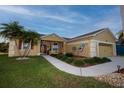 Beautiful exterior showcasing manicured lawn, decorative elements, and an attached two-car garage at 7113 91St E St, Palmetto, FL 34221