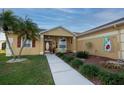 Inviting front entrance with decorative door, well-maintained landscaping, and a welcoming walkway at 7113 91St E St, Palmetto, FL 34221