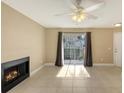 Cozy living room with tile floor, sliding door, fireplace, and neutral color scheme at 850 S Tamiami Trl # 301, Sarasota, FL 34236