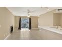 Open living space with tile flooring, ceiling fan, fireplace, and sliding door leading to the outdoors at 850 S Tamiami Trl # 301, Sarasota, FL 34236