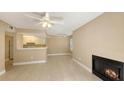 Open living space with tile floors, fireplace, and adjacent kitchen featuring white cabinetry at 850 S Tamiami Trl # 301, Sarasota, FL 34236