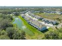Community aerial showcasing pond views, lush greenery, and well-maintained townhome exteriors at 8612 Milestone Dr, Sarasota, FL 34238