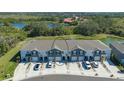Aerial view of new townhomes featuring attached garages and well-kept landscaping in a peaceful setting at 8612 Milestone Dr, Sarasota, FL 34238