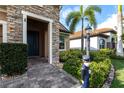Close up of the entrance to this charming home with stone accents and manicured landscaping at 11679 Renaissance Blvd, Venice, FL 34293