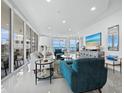 Airy living room with ocean views, contemporary furnishings, and sleek tile flooring at 3010 Grand Bay Blvd # 482, Longboat Key, FL 34228