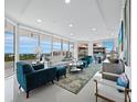 Bright living room with floor-to-ceiling windows offering panoramic views, and modern decor at 3010 Grand Bay Blvd # 482, Longboat Key, FL 34228