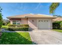 Charming single-story home featuring a tile roof, manicured lawn, and a two-car garage with a well-maintained driveway at 4414 Turnberry Ct, Bradenton, FL 34210
