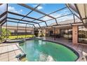 Screened-in pool area featuring a pool, spa, and ample patio space for outdoor enjoyment at 534 Warwick Ln, Venice, FL 34293