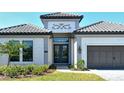 Elegant home featuring double door entry and a two-car garage with stone driveway at 552 Bocelli Dr, North Venice, FL 34275
