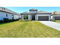 Charming curb appeal with green lawn and stylish exterior design at 552 Bocelli Dr, North Venice, FL 34275