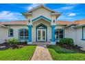 Inviting entrance with blue accents and well manicured landscape at 5750 Saddle Oak Trl, Sarasota, FL 34241