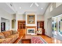 Cozy living room featuring a fireplace, built-in shelving, and lots of natural light at 5750 Saddle Oak Trl, Sarasota, FL 34241