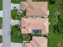 Aerial view of a single-Gathering home with a screened-in pool and a tile roof at 8503 Gateway Ct, Englewood, FL 34224