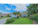 Beautiful single-story home featuring lush landscaping, a well-manicured lawn, and mature trees at 8503 Gateway Ct, Englewood, FL 34224