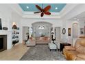 Cozy living room featuring tile floors, archways, neutral colors, and ample natural light at 10912 Big Bass Pl, Bradenton, FL 34212