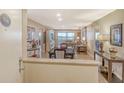 Open-concept living and dining area with neutral colors and a view of the city at 1125 W Peppertree Dr # 706, Sarasota, FL 34242