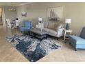 Bright living room featuring neutral decor, a stylish area rug, and comfortable seating, perfect for entertaining at 12229 Amica Loop, Venice, FL 34293