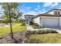 Well-manicured front lawn and walkway leading to a charming single-story house with gray exterior at 12518 Oak Hill Way, Parrish, FL 34219