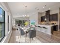 Open living space with kitchen, dining, and sitting area, with natural light at 12518 Oak Hill Way, Parrish, FL 34219