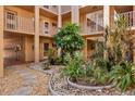 Relax in the beautiful courtyard with mature landscaping and winding stone paths at 1330 Glen Oaks E Dr # 174D, Sarasota, FL 34232