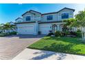 Charming two-story home with brick driveway, lush lawn and well-maintained landscaping at 16438 Slate Pl, Lakewood Ranch, FL 34211