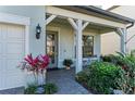 Inviting front porch featuring brick flooring, and decorative plants and shrubbery at 16438 Slate Pl, Lakewood Ranch, FL 34211