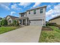 Beautifully maintained two-story home with attached garage and lush green lawn at 17119 Harvest Moon Way, Bradenton, FL 34211