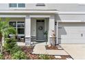 Inviting front entrance featuring a cozy sitting area and tasteful landscaping at 17119 Harvest Moon Way, Bradenton, FL 34211