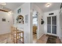 Hallway with barstool seating, kitchen view, and an entryway door on the right at 2907 51St W Ave, Bradenton, FL 34205
