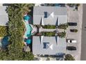 Bird's eye view of two-unit property with a shared kidney bean-shaped pool and tropical landscaping at 3007 Avenue E # A, Holmes Beach, FL 34217