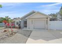 Well-kept home showing the garage door, driveway, and manicured landscaping at 5002 Bunyan St, Sarasota, FL 34232