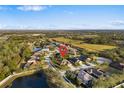 Aerial view of a residential neighborhood with ponds and green spaces under a blue sky at 5814 117Th E Ter, Parrish, FL 34219