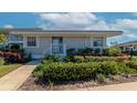 Exterior elevation shows the front of a building with fresh landscaping and neutral color scheme at 617 Estuary Dr # 617, Bradenton, FL 34209