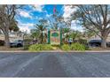Grand Oak at the Preserve community sign with lush landscaping and the American flag at 6326 Grand Oak Cir # 203, Bradenton, FL 34203