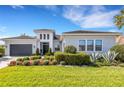 Charming single-story home with manicured lawn, mature landscaping, and a two-car garage at 8901 Artisan Way, Sarasota, FL 34240