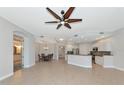 Open-concept space includes neutral tile floors, white walls, ample lighting, and seamless transition between spaces at 9415 Discovery Ter # 101A, Bradenton, FL 34212